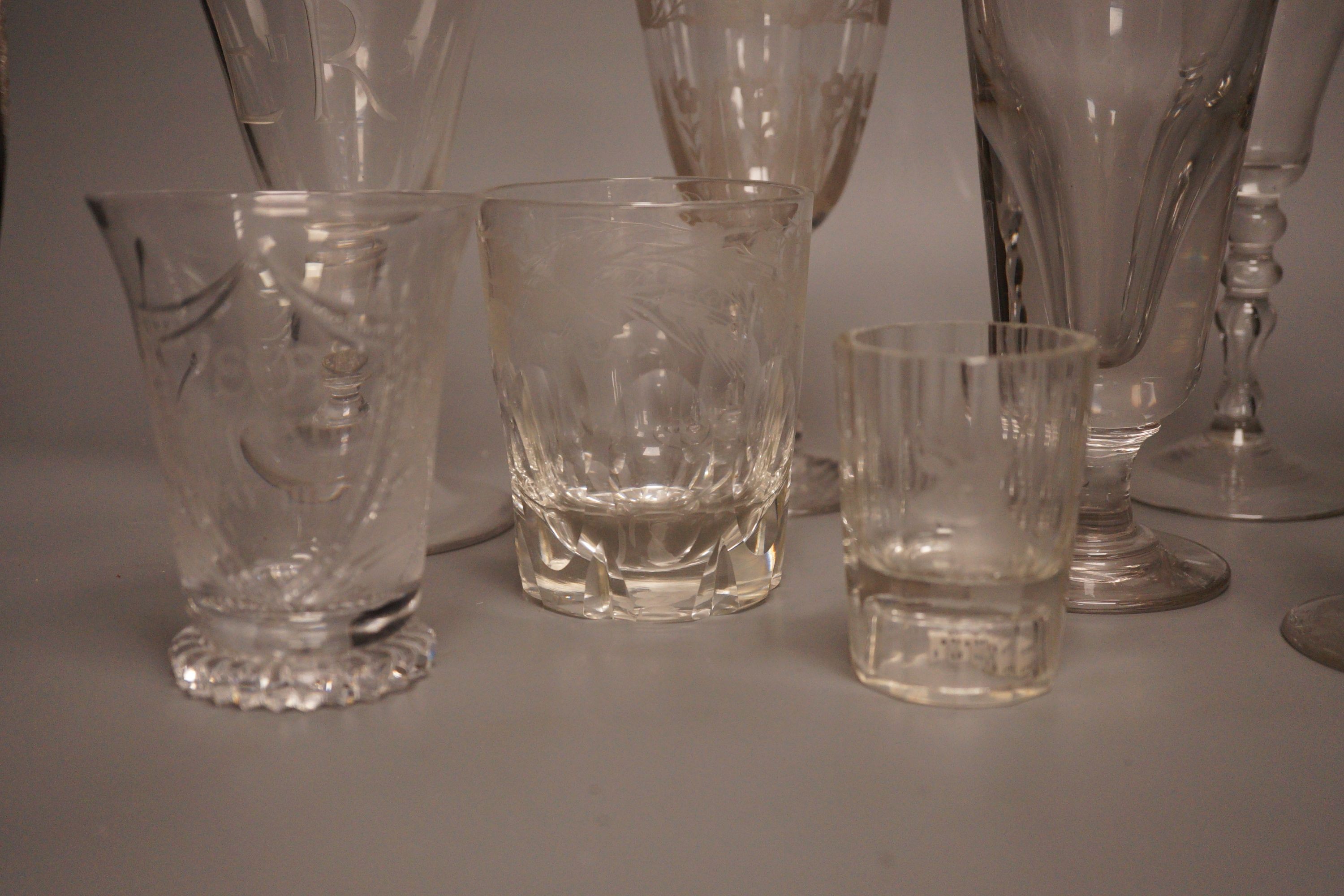 A group of eight 19th/20th century novelty or commemorative glasses, tallest 19.5 cm, including two deceptive glasses, a wheel engraved tumbler with hangman to the base etc.